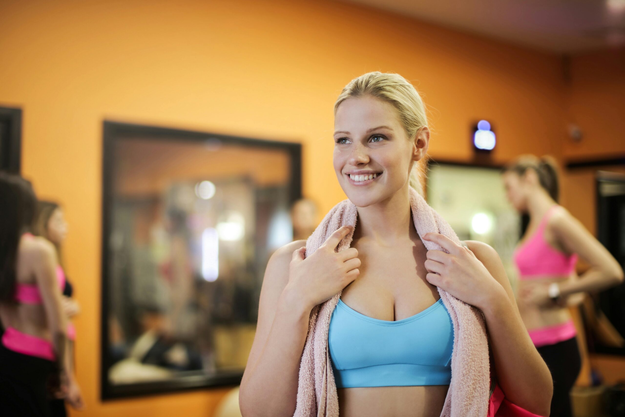 Group of women exercising indoors in a gym, reflecting healthy lifestyle and fitness.